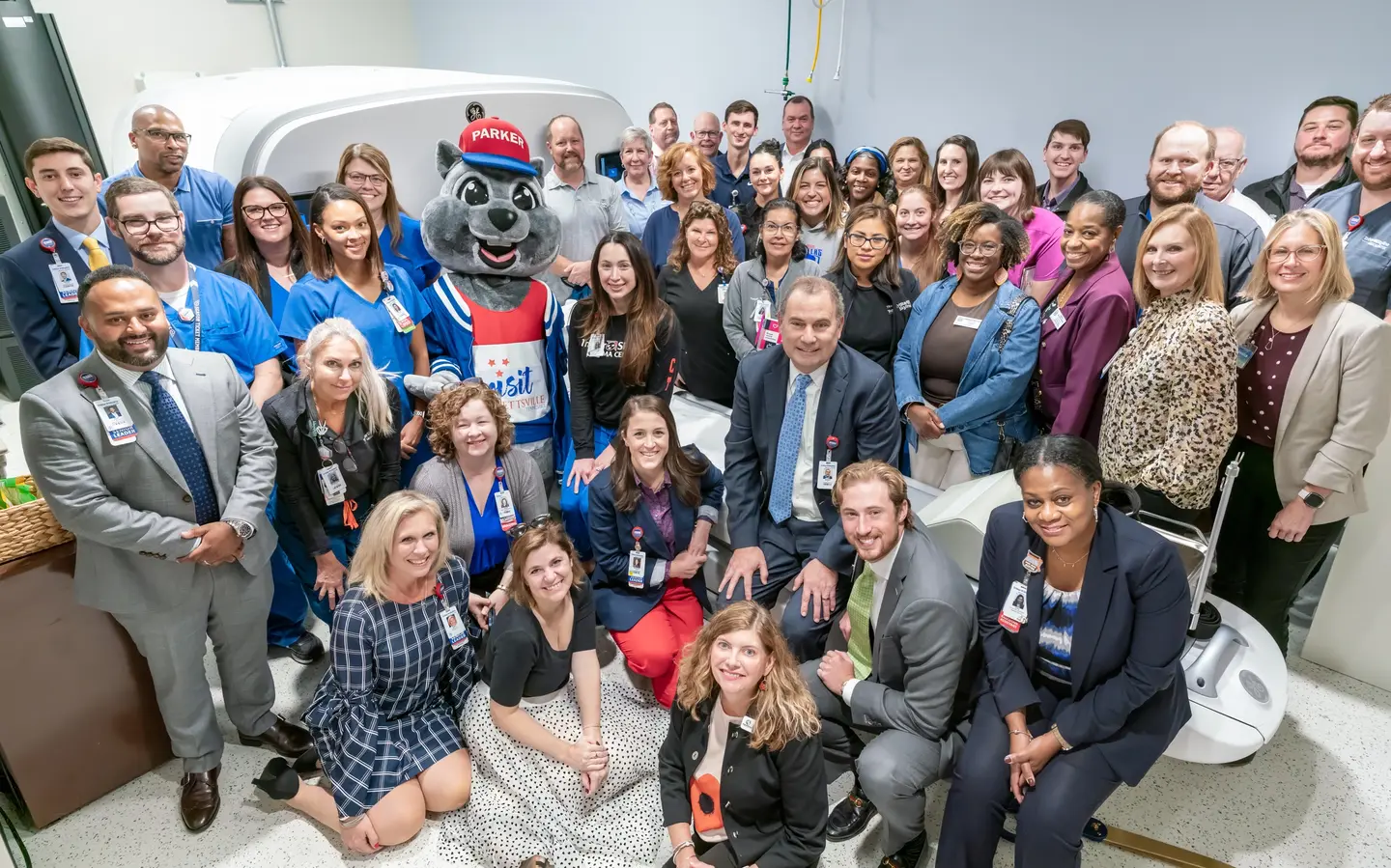 photo: members from both the Madison-Rivergate and Goodlettsville chambers of commerce as well as colleagues, community members, board members, and providers seated and standing around the new PET/CT scanner at TriStar Skyline Medical Center during the recent ribbon cutting
