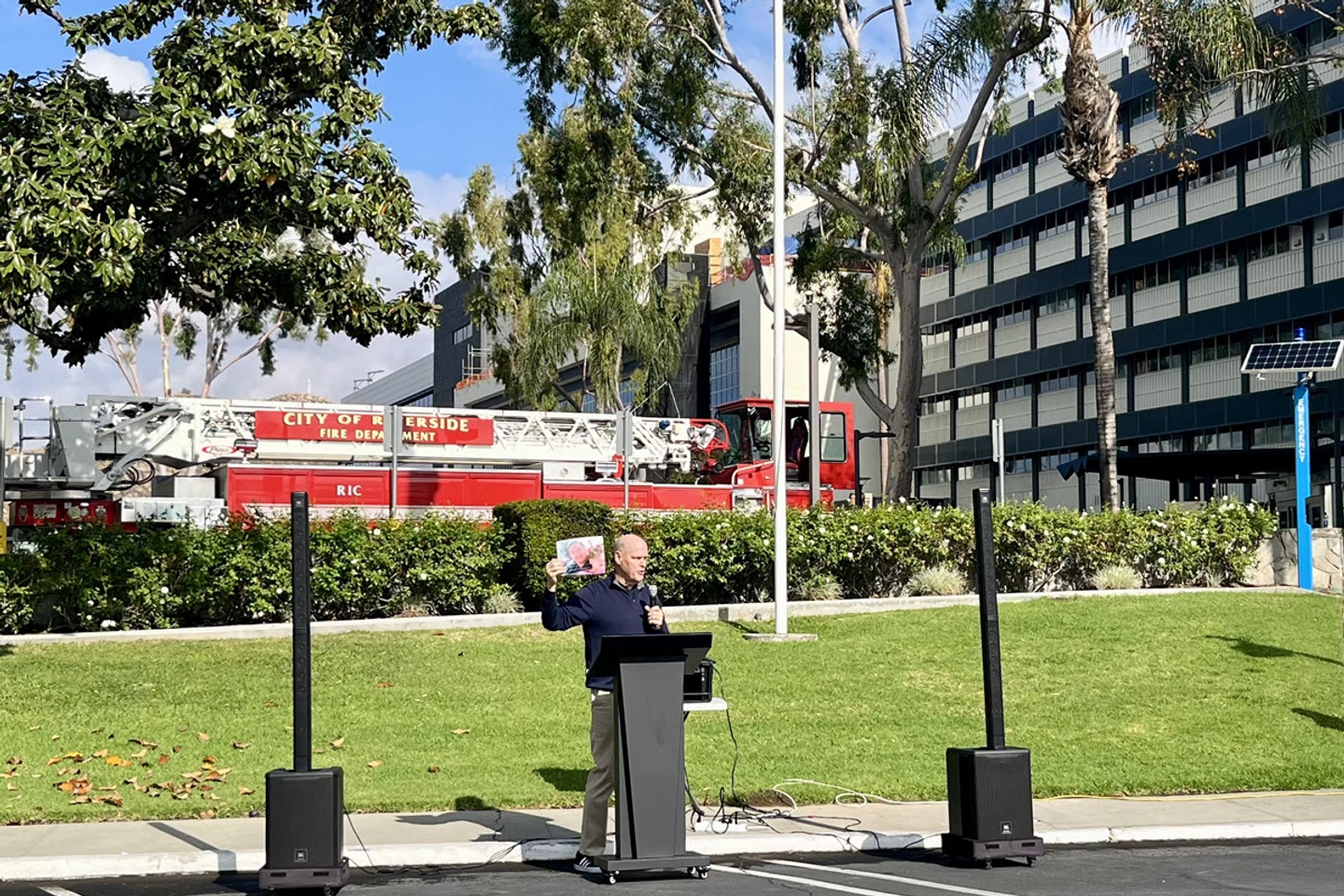 OneLegacy ambassador and organ donor recipient John Whalen, holding a photo of his organ donor.