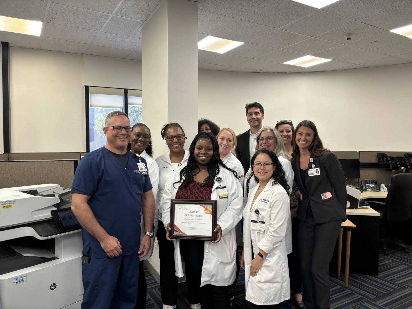 A group of members of Pasadena hospital pose with an award.