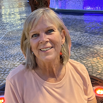 Gaylynn Child smiles while wearing a pastel pink shirt.