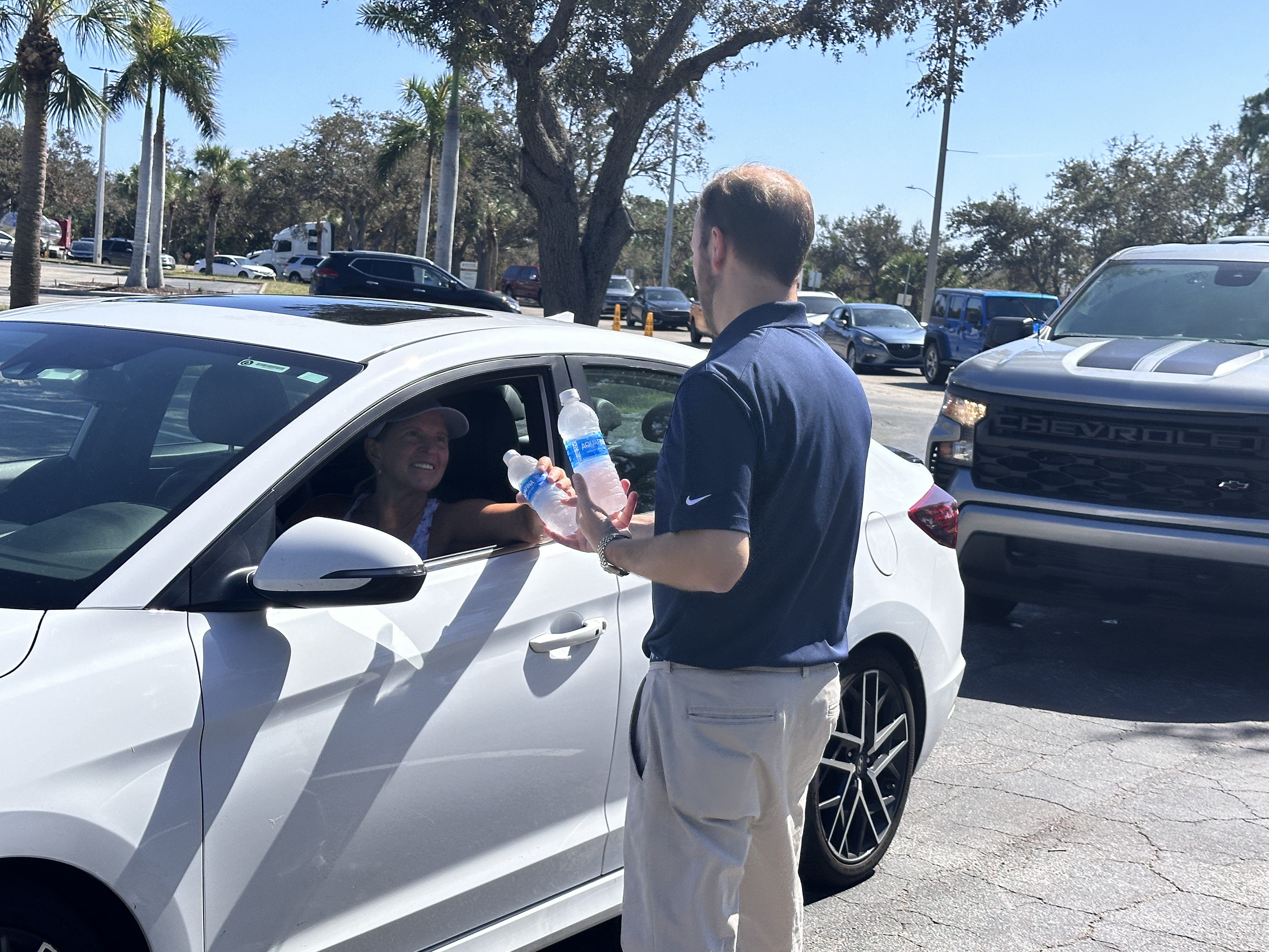 HCA Florida Englewood Hospital CEO Joe Rudisill passed out waters to employees who were lined up to receive free fuel.