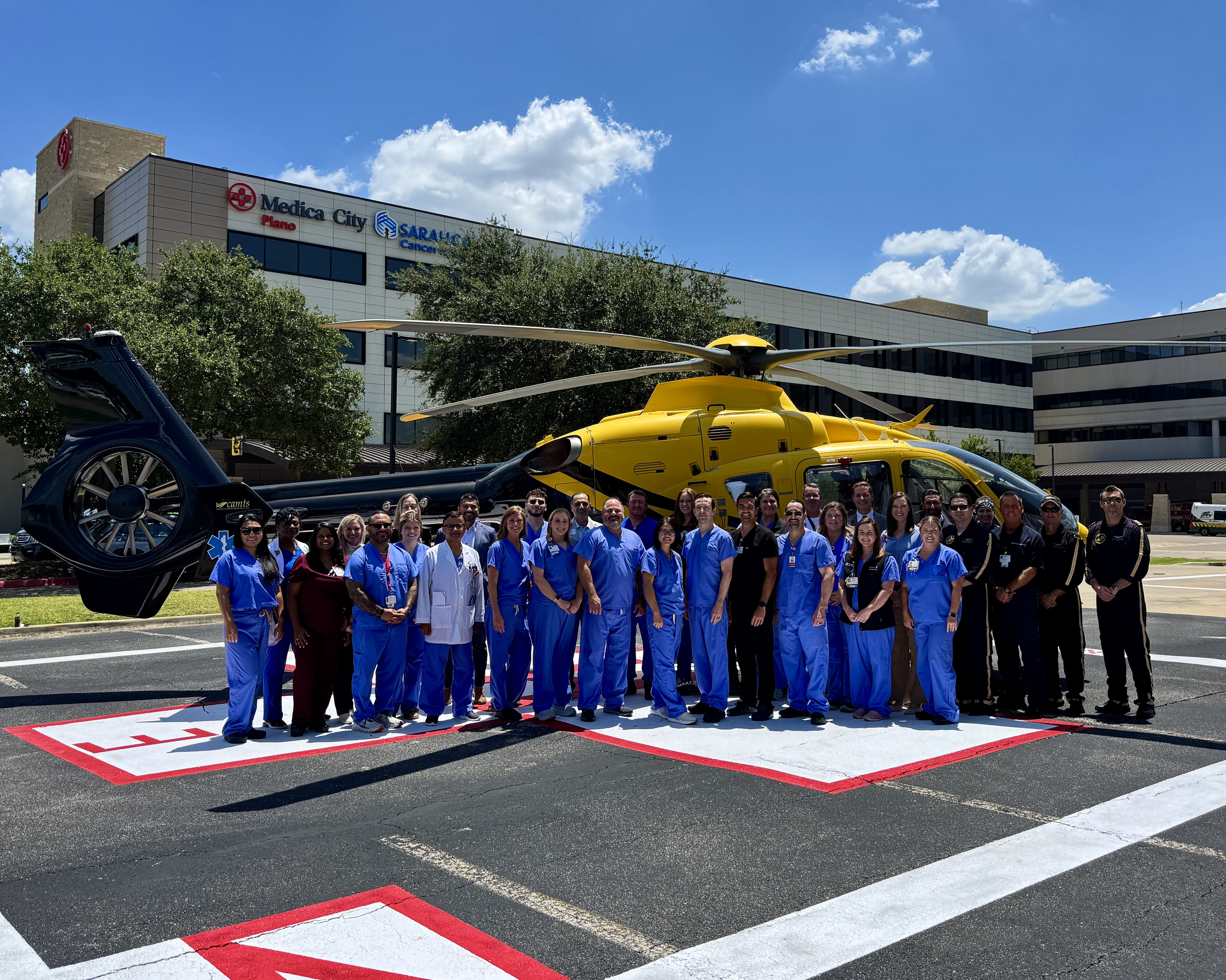 Plano Life Support team in front of a yellow helicopter.