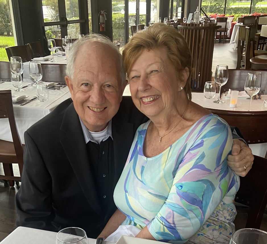 A married man and woman smiling at a table in a restaurant