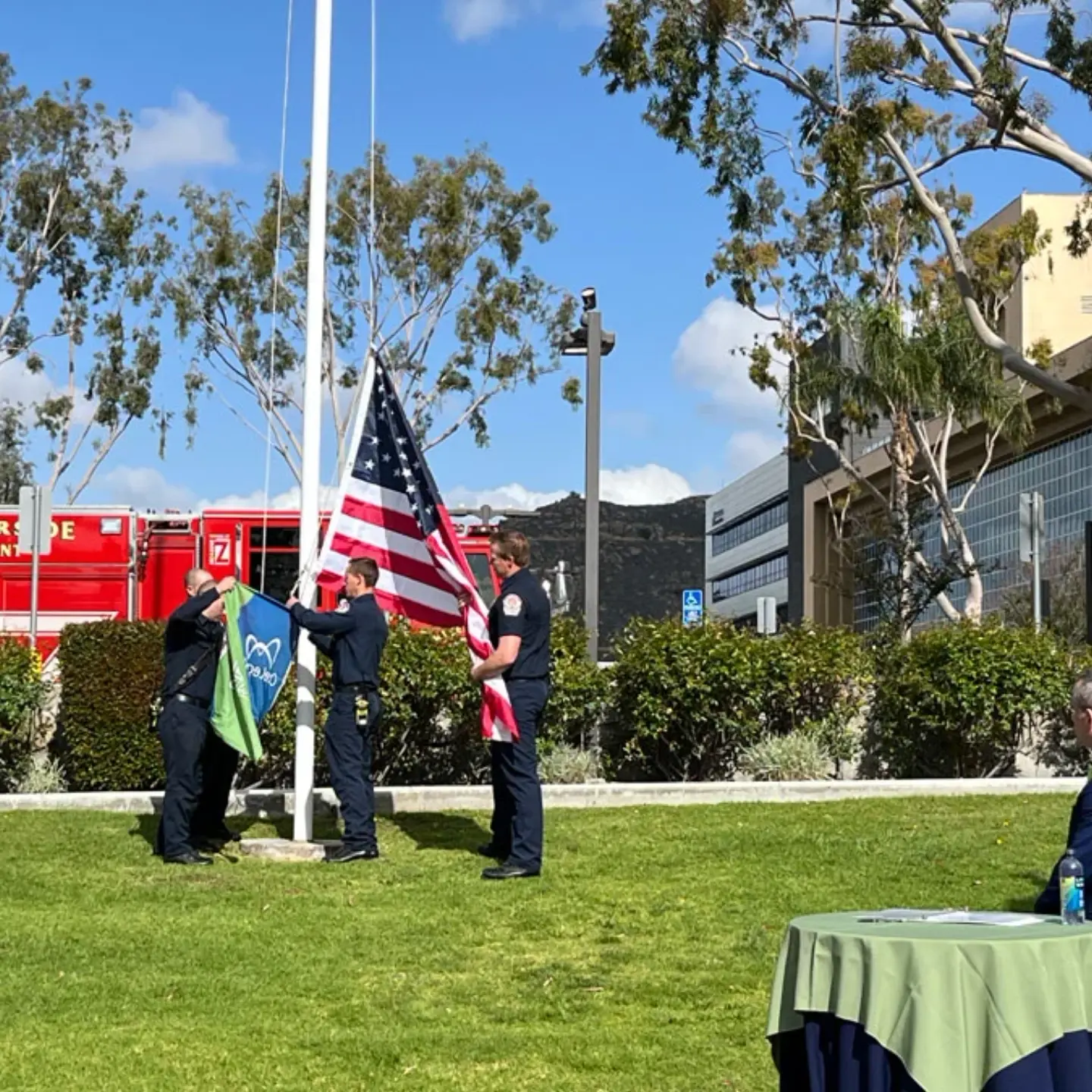 First responders raise the American and Donate Life flags on the flagpole before the Donate Life ceremony.