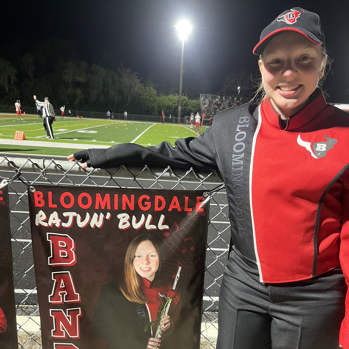 Hannah in band uniform at football game.
