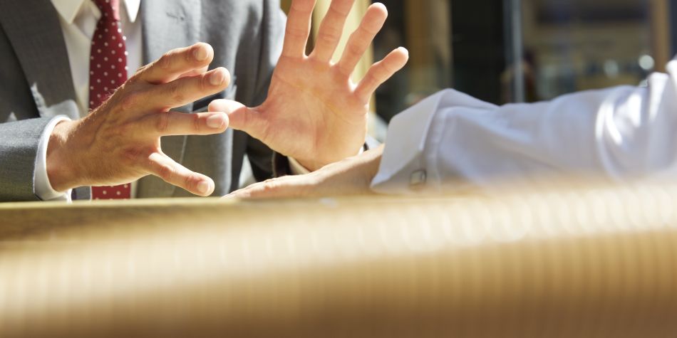 A businessman's hands making a gesture.
