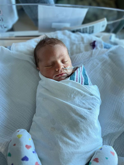 Baby Hugo sleeping swaddled in the hospital.