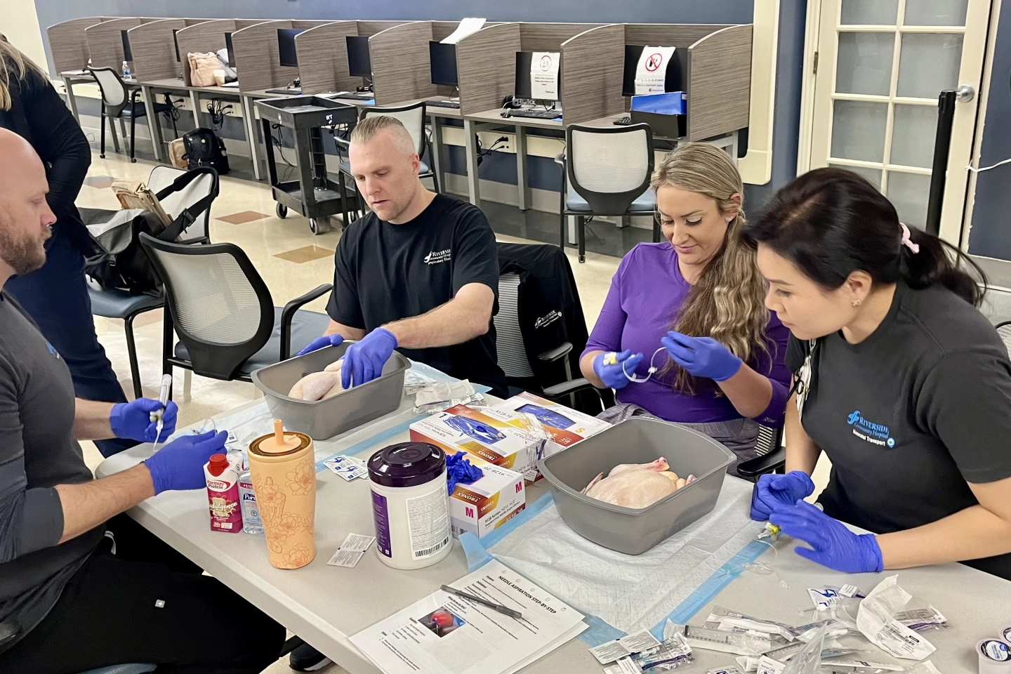 NICU nurses and Respiratory Therapists doing hands-on simulation learning.