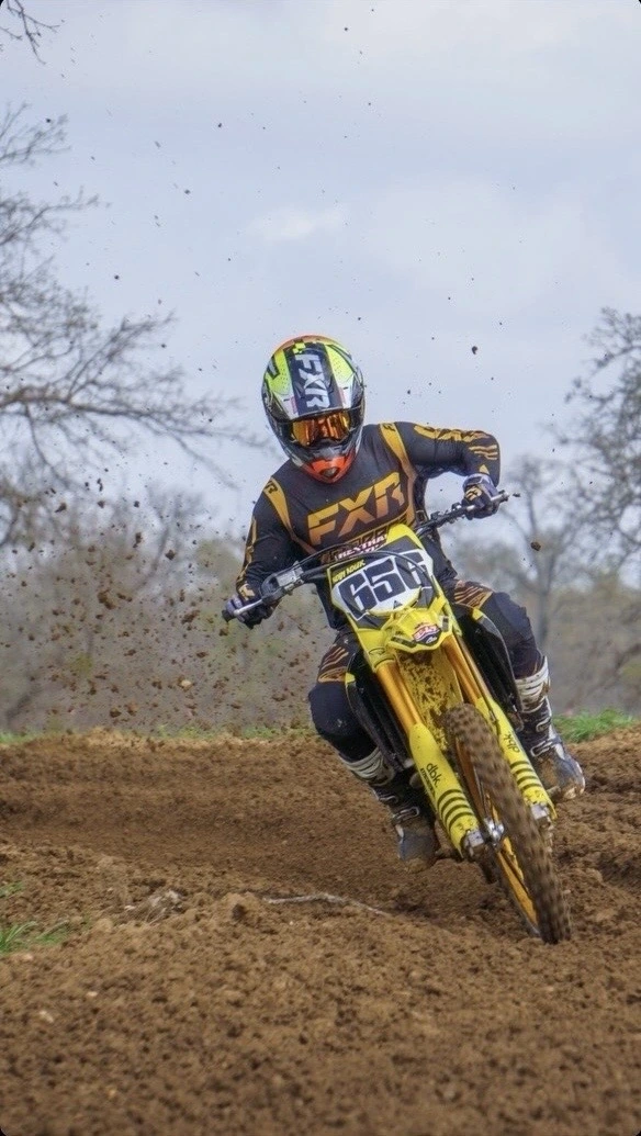 Kody riding his dirt bike on a dirt track