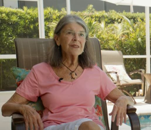 Photo of Denise Levin sitting in a chair.