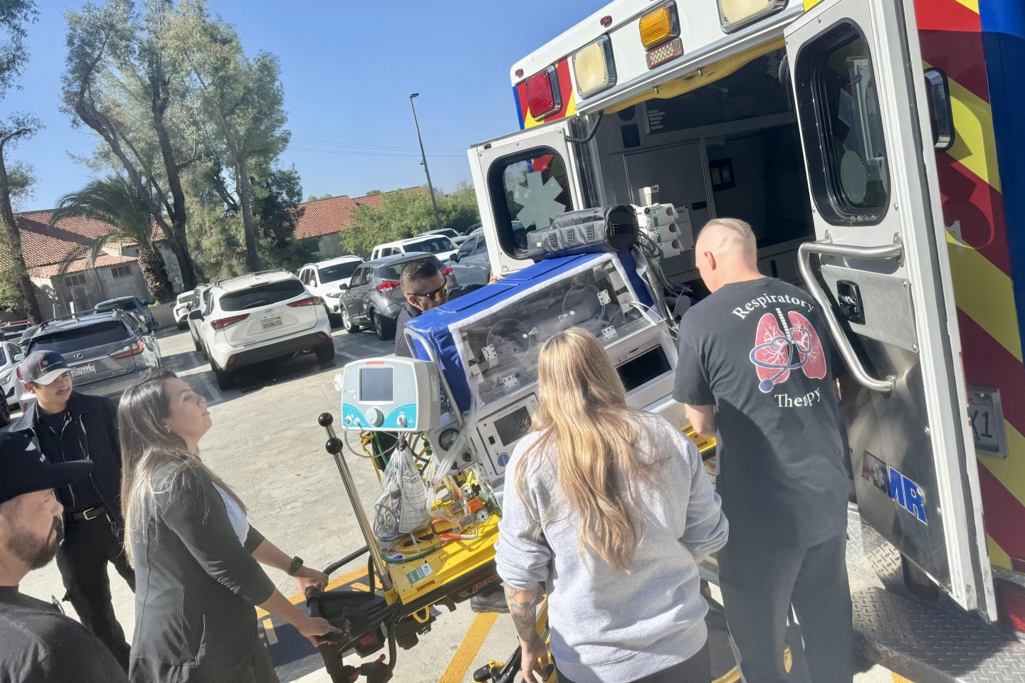 The NICU Transport team unloading the specialized transport patient bed.
