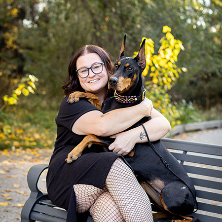Samantha Rosas holding her dog on a park bench.