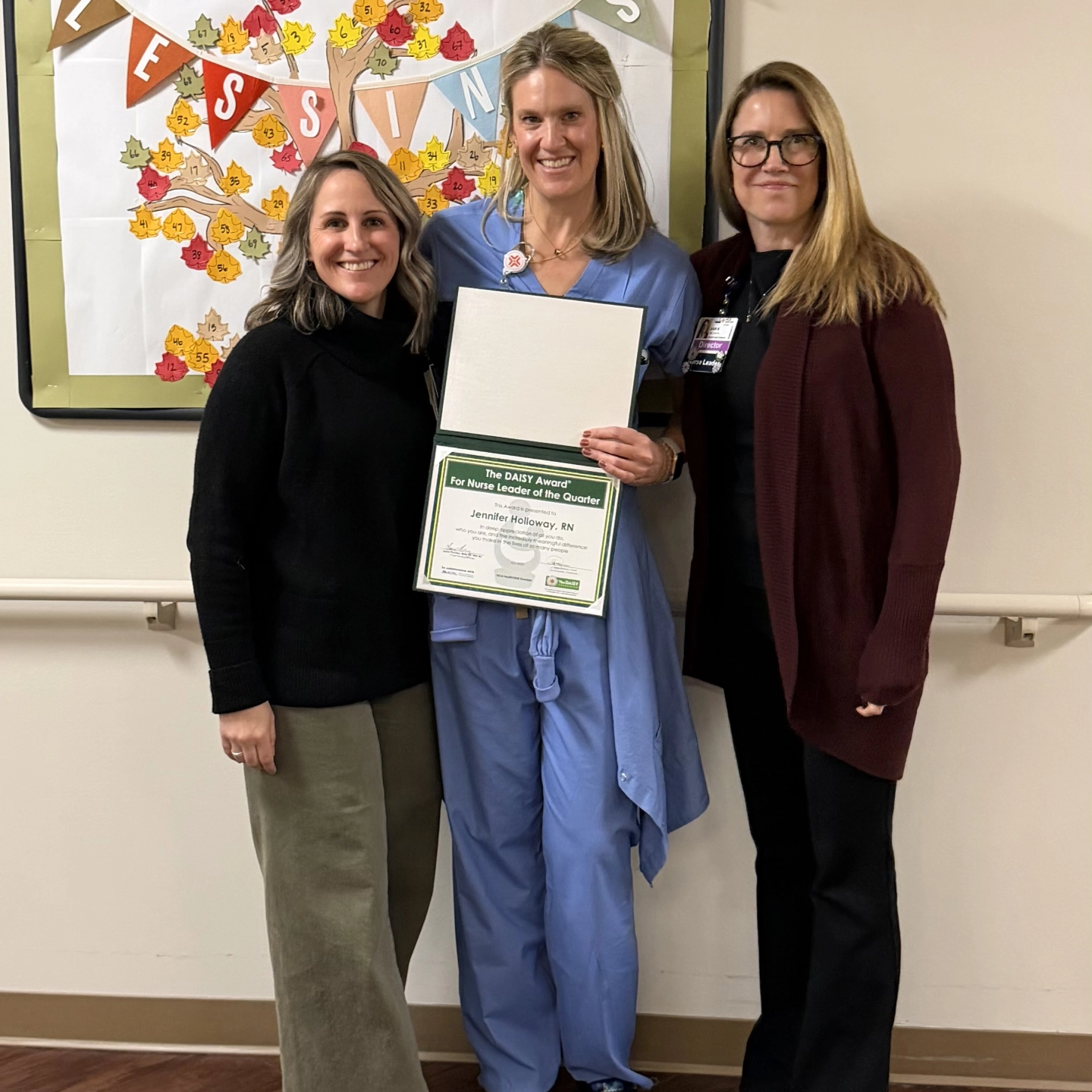 three ladies holding award