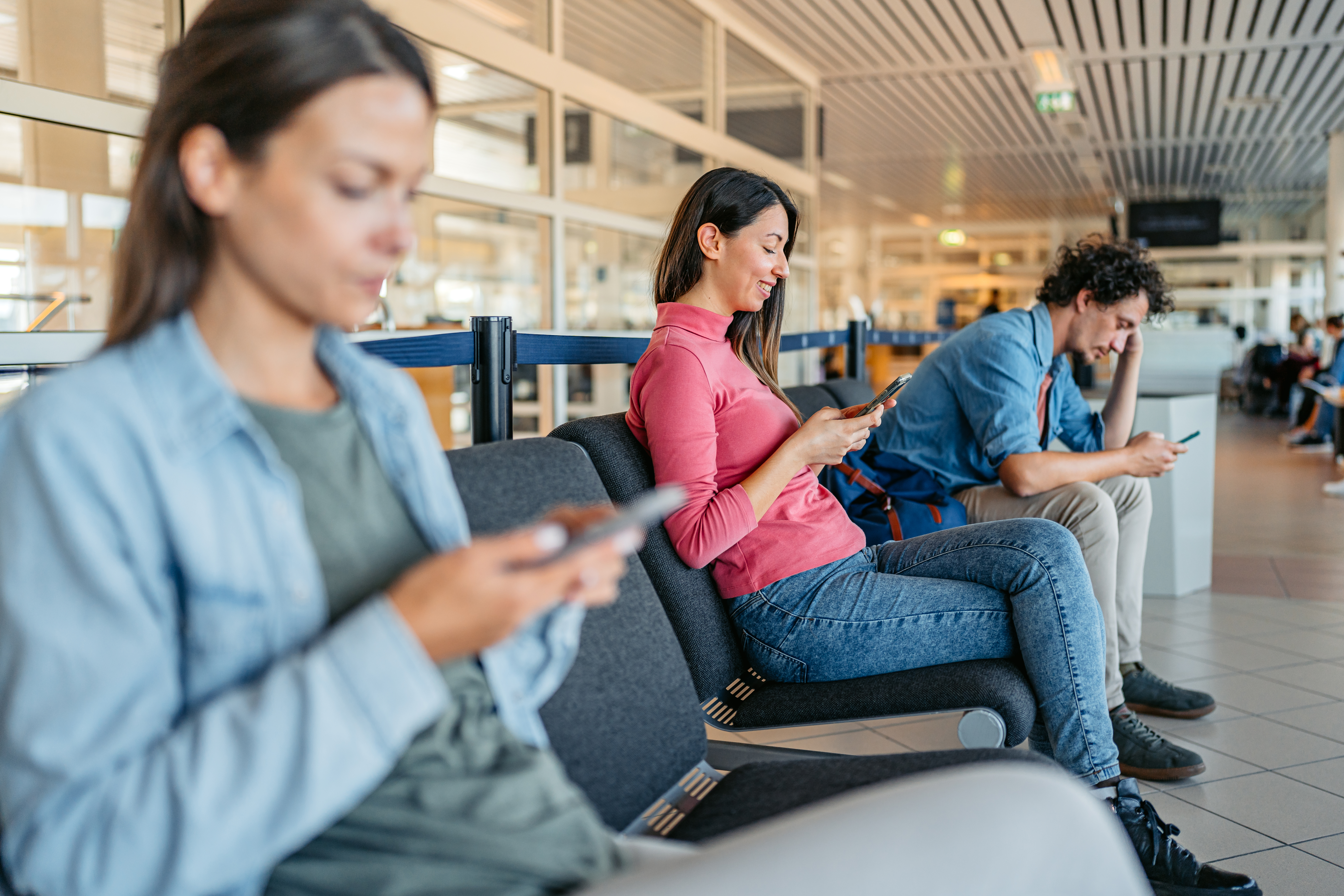 Travelers looking at their phones.