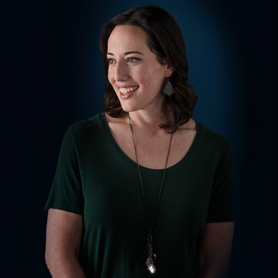 Elyse F. smiling, wearing a green shirt.