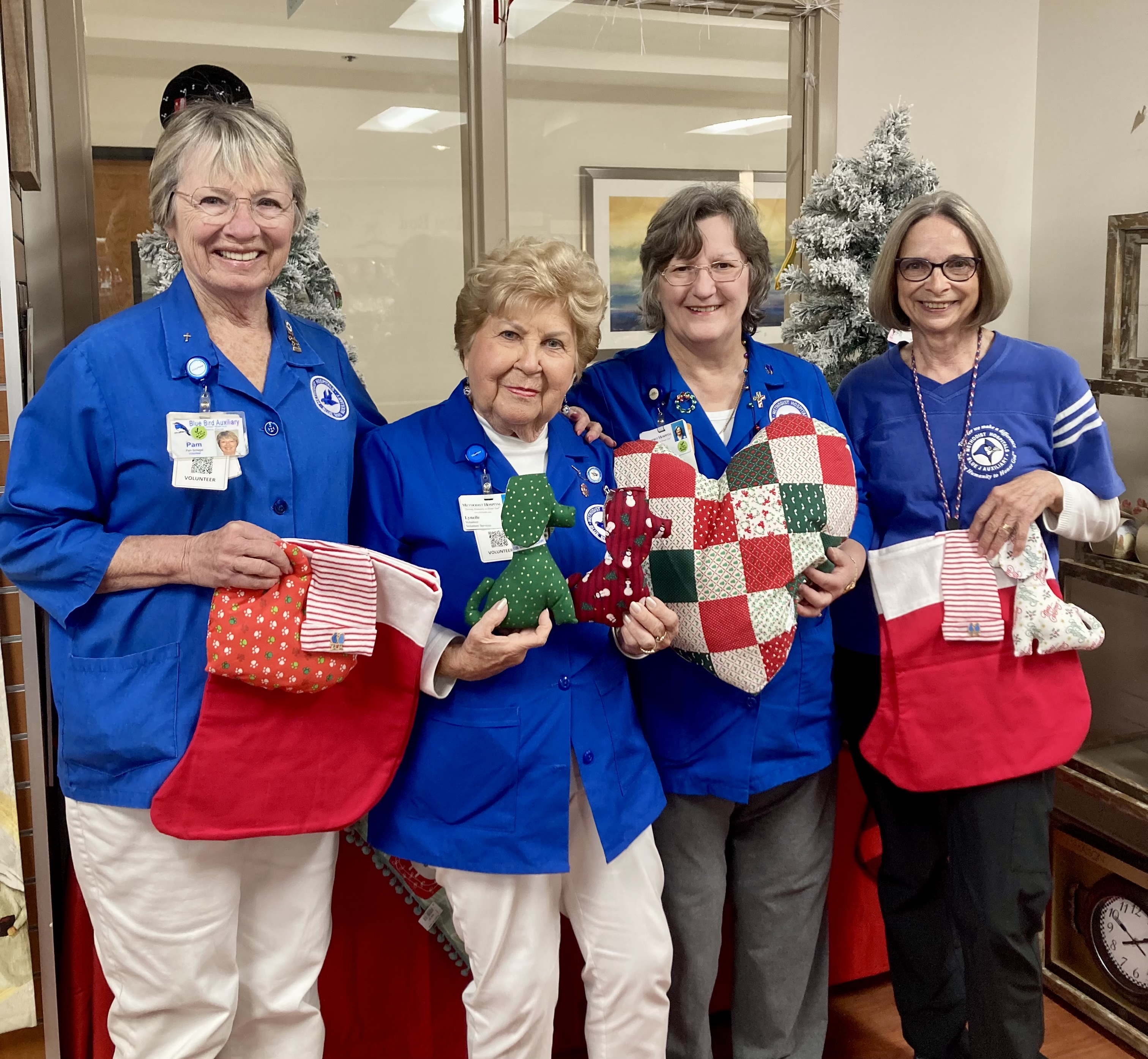 Members of the Blue Bird holding hand stitched stockings