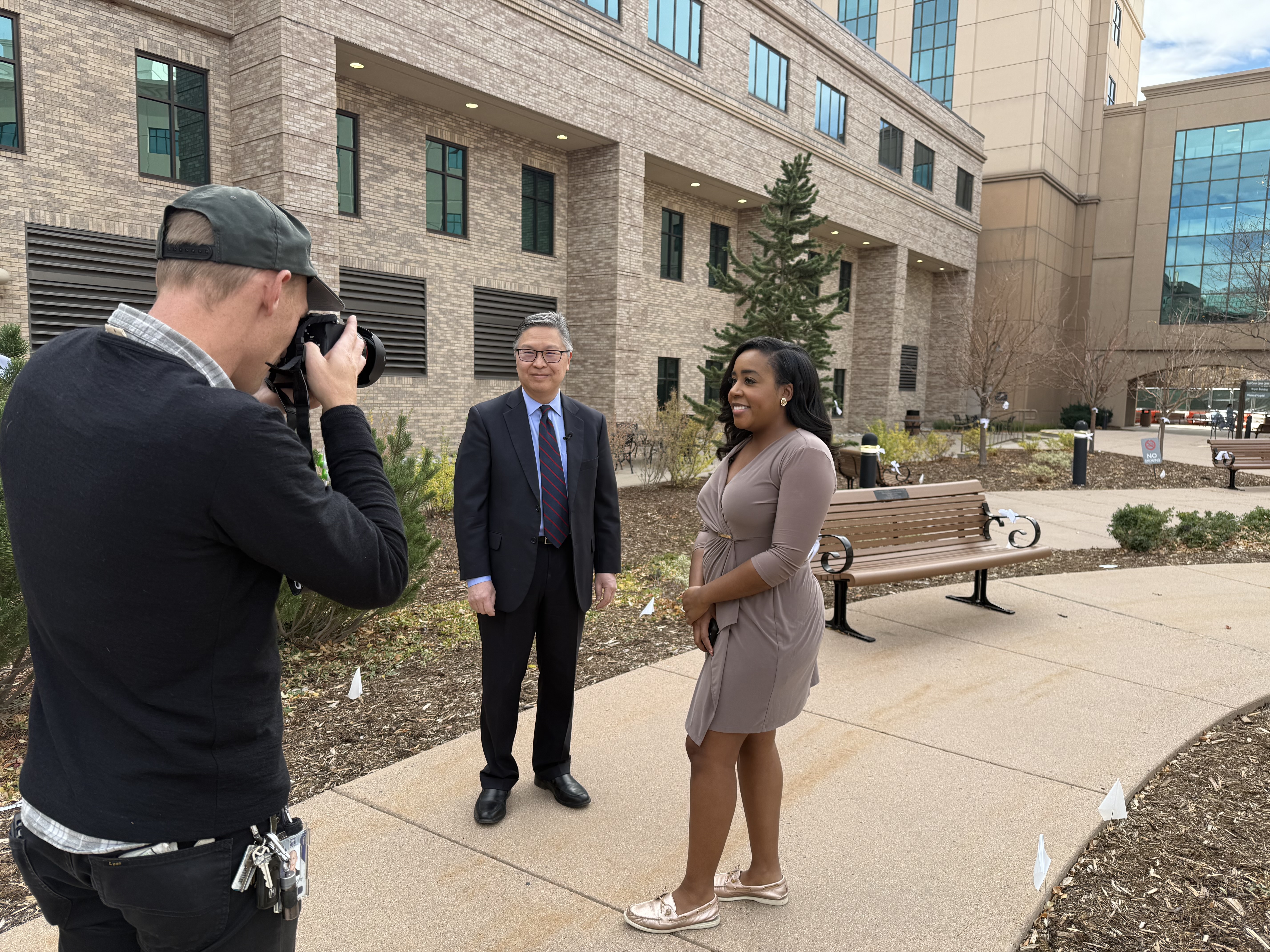 Dr. Frank Chae visits with Denver7’s Micah Smith in hospital courtyard.