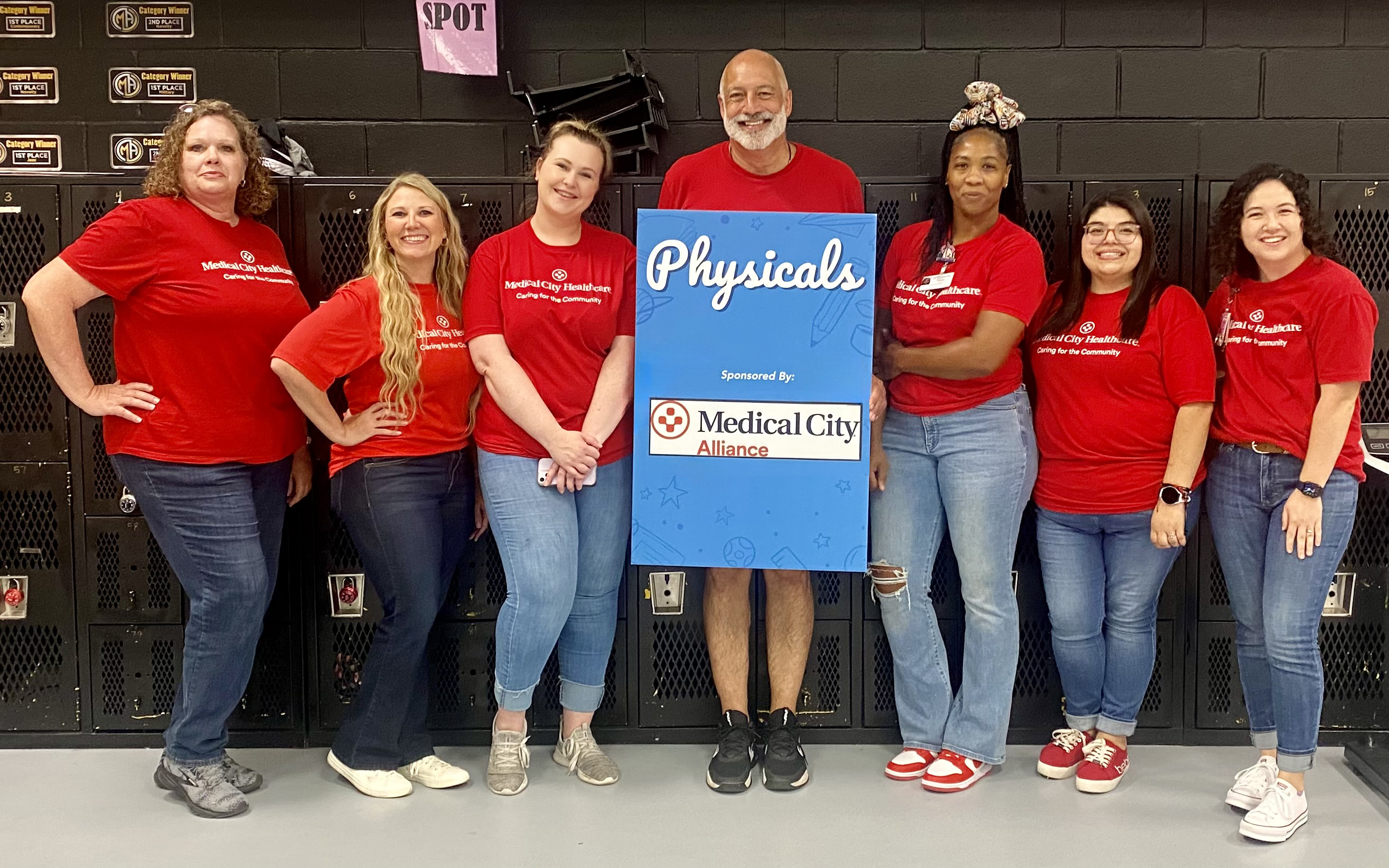Medical City Alliance colleagues sport red "Caring for the Community" t-shirts at the Keller Independent School District's Back to School bash.