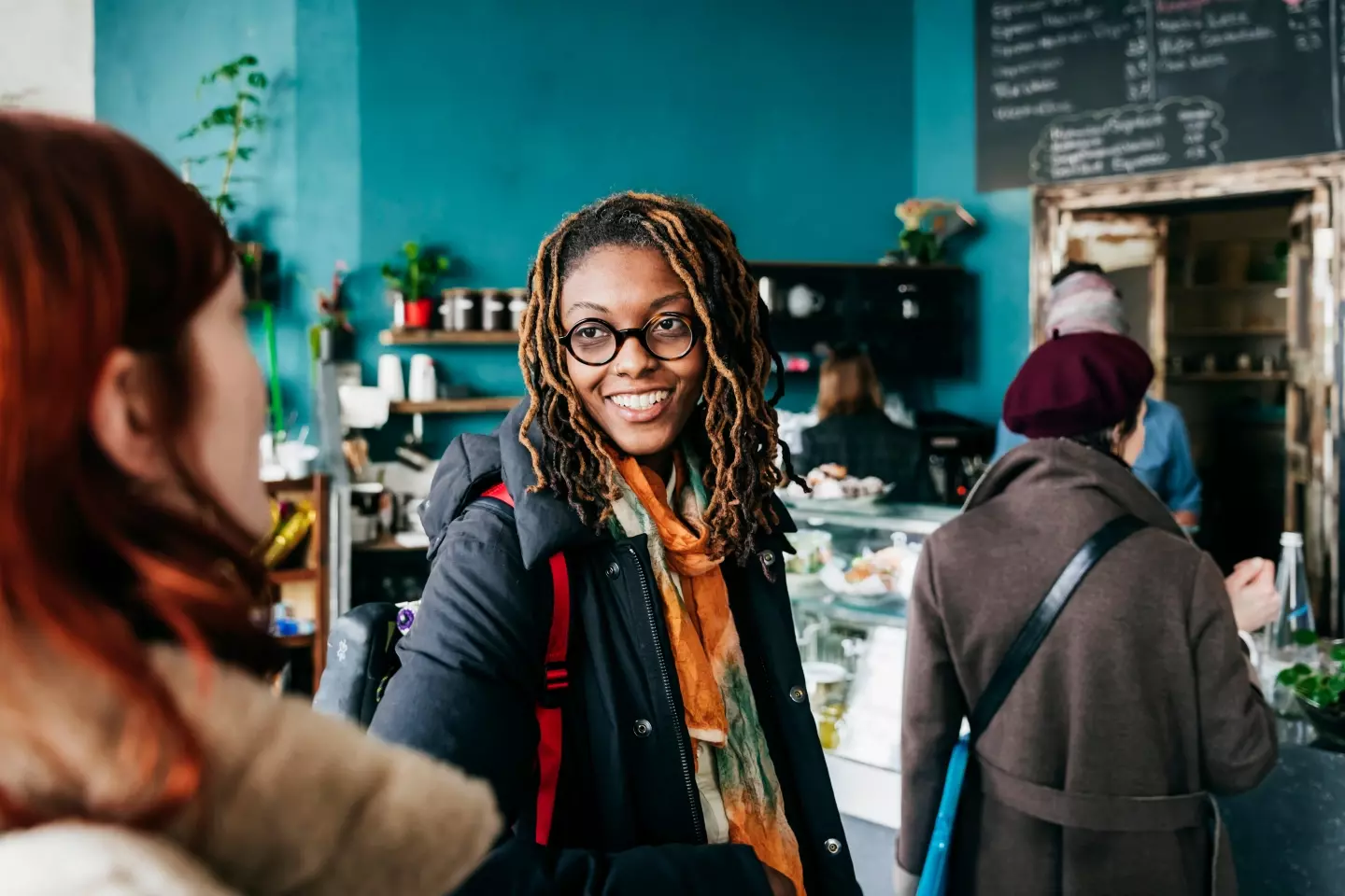 People waiting in line at a cafe.