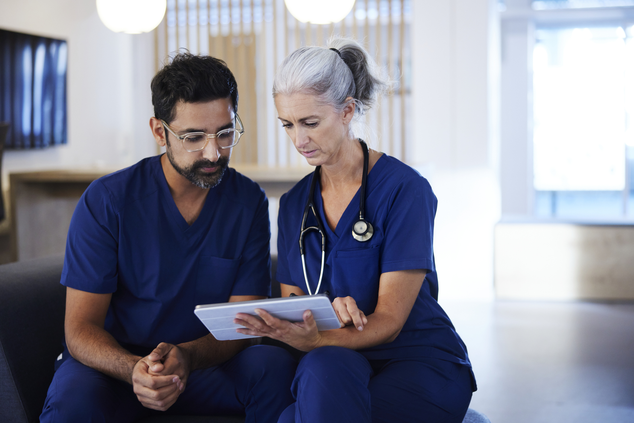 Doctors looking at tablet