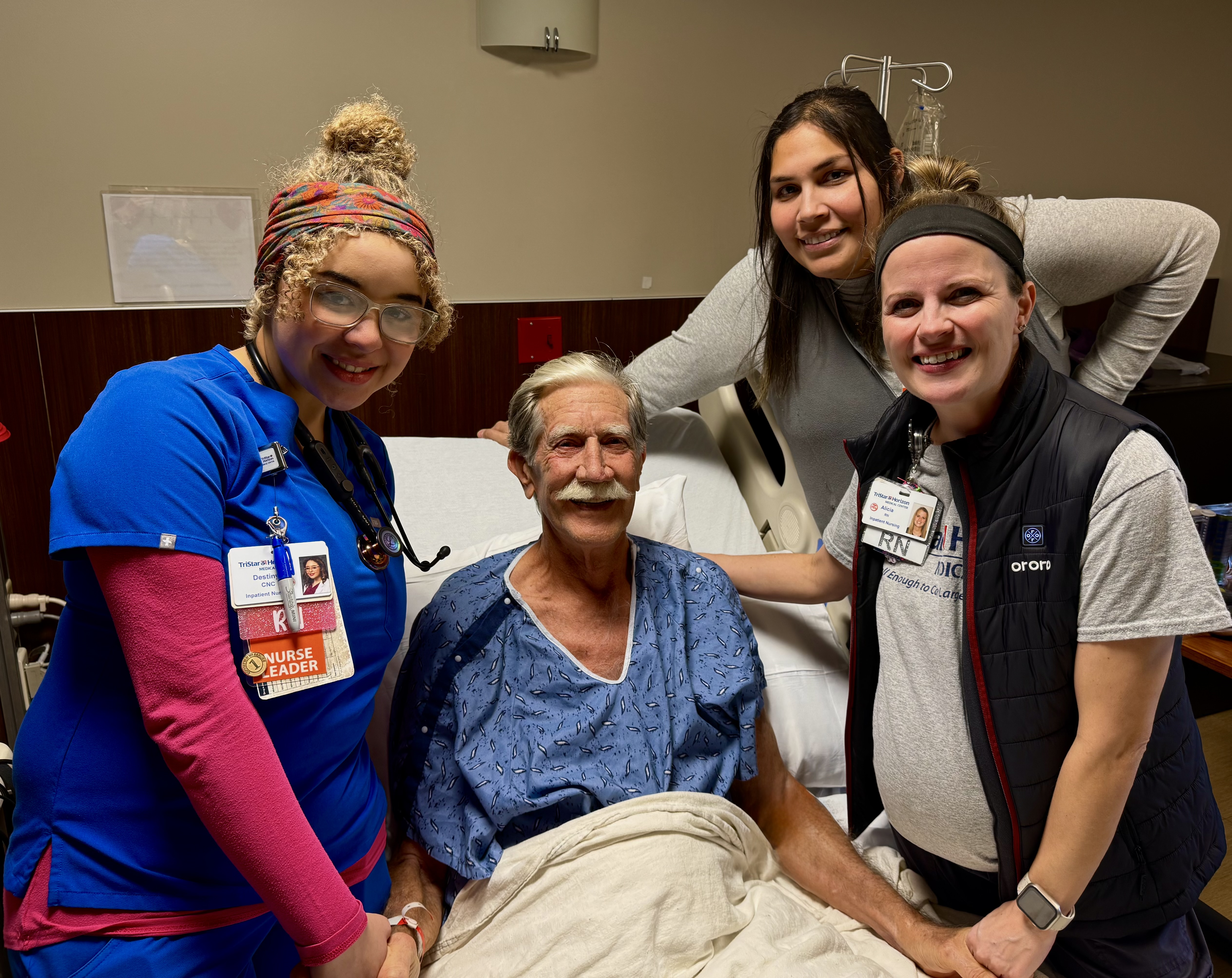 TriStar Horizon patient pictured in a hospital room surrounded by three nurses.
