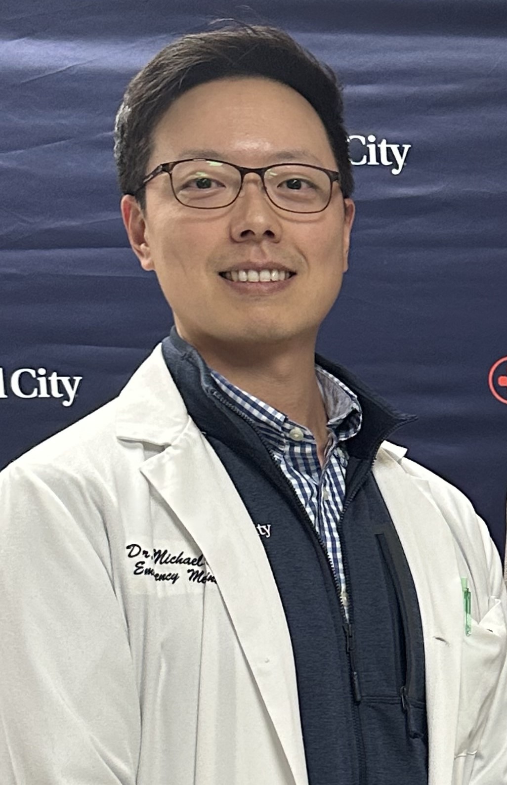 Dr. Michael Hong in lab coat.