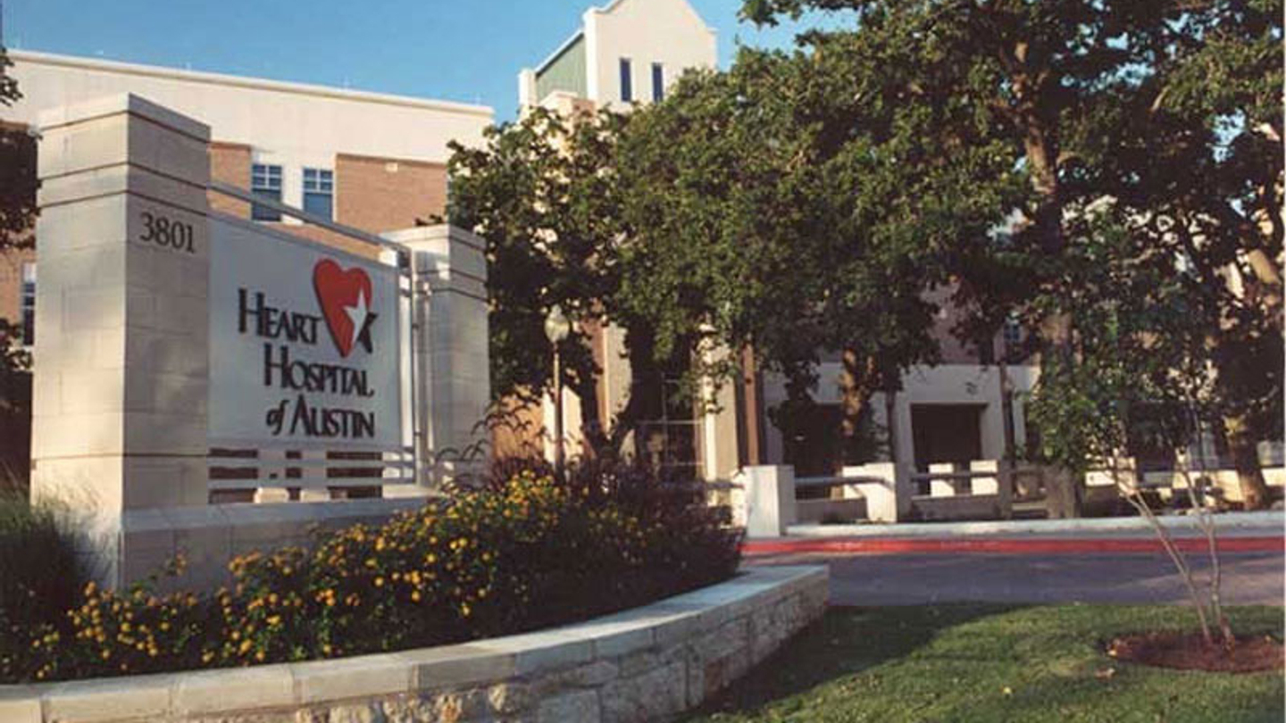 Exterior main entrance of the Heart Hospital of Austin on a sunny day.