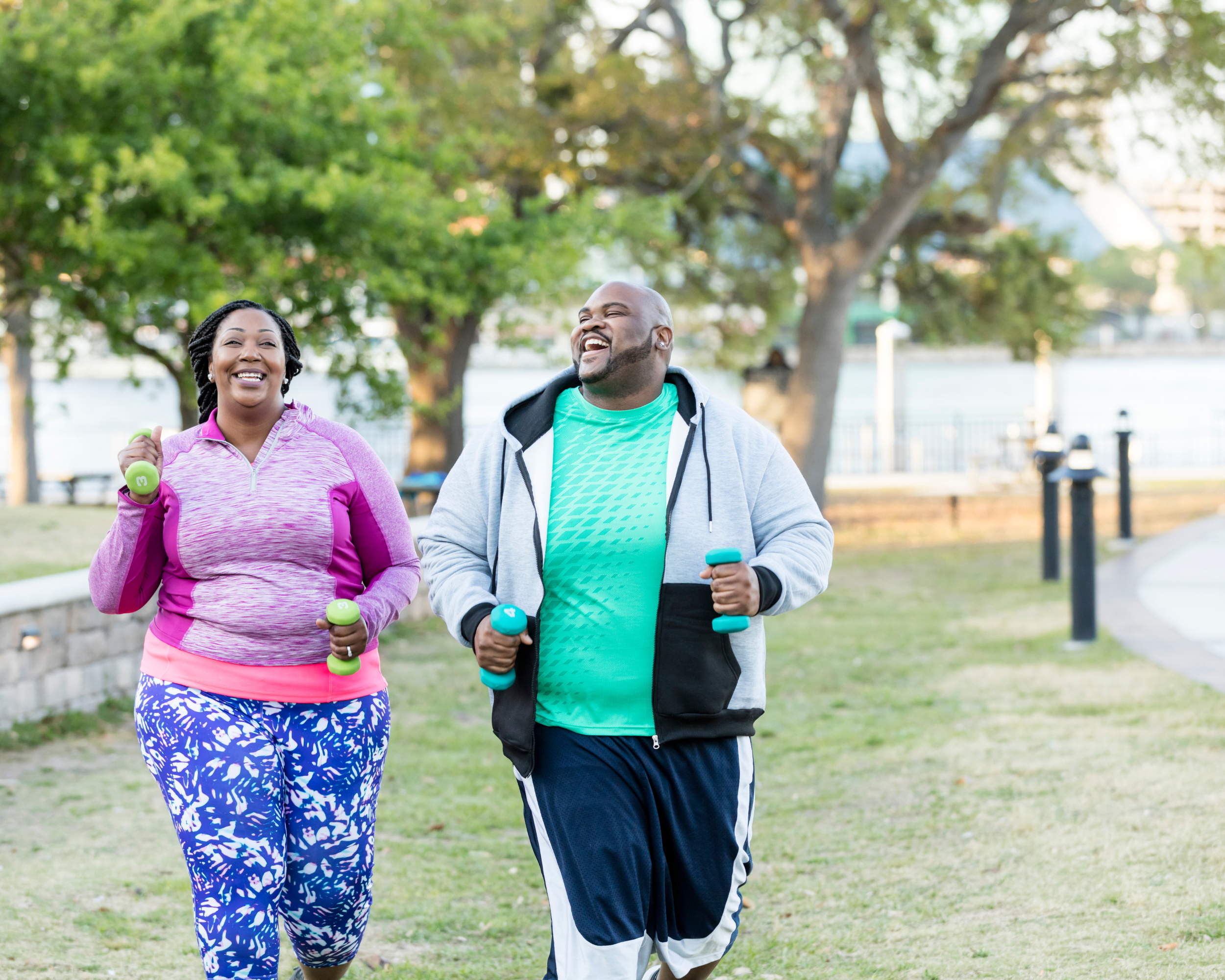Two people outside exercising.