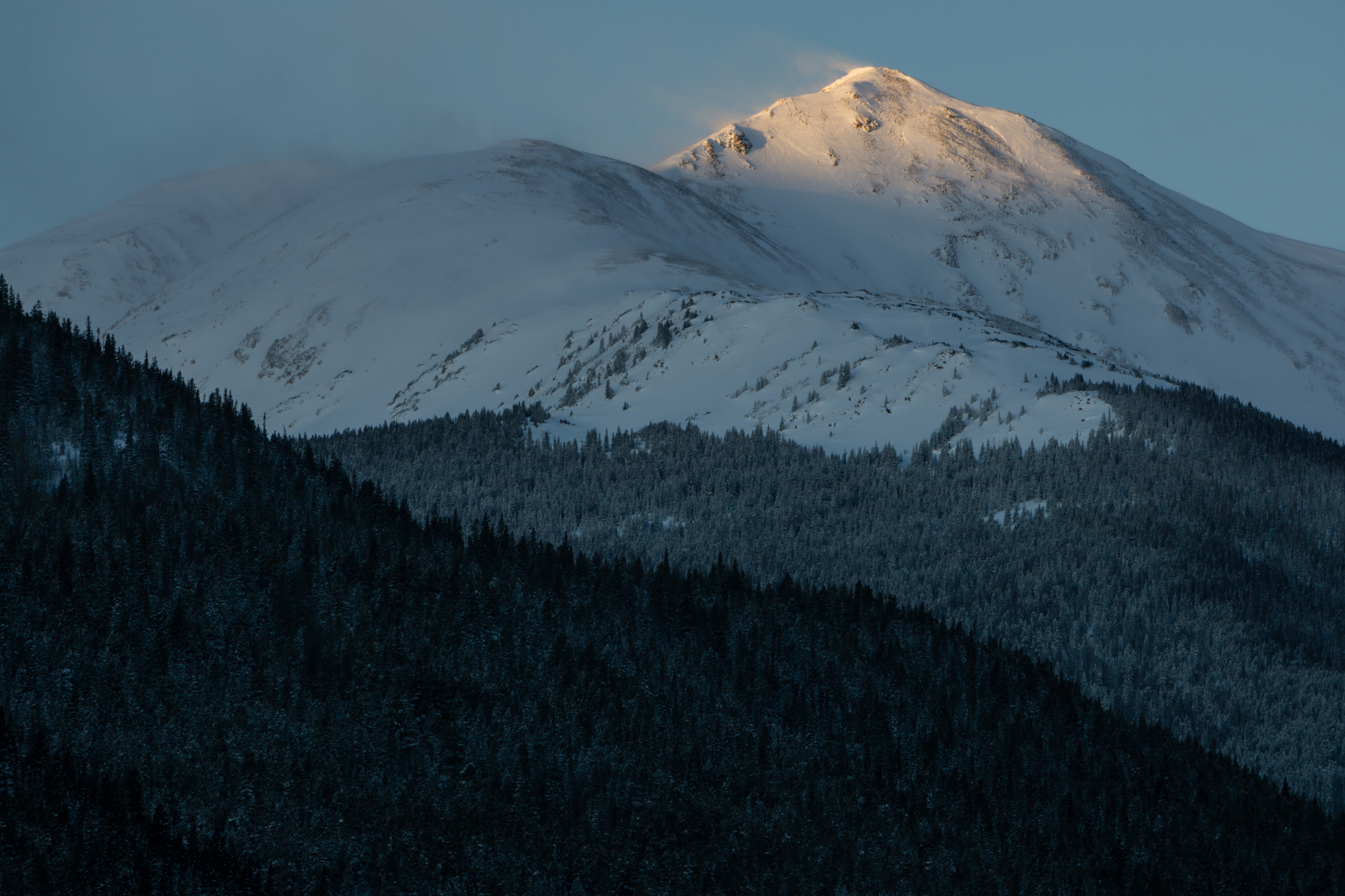 A mountaintop lighted by the sun.