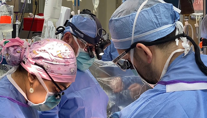 Doctors in a surgery room doing a procedure.
