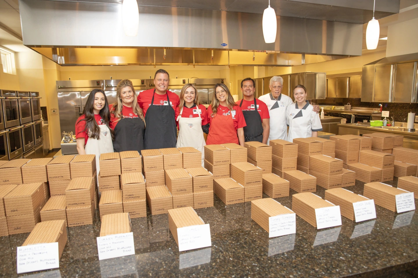 Medical City Dallas and Medical City Children’s Hospital colleagues pack boxes to serve lunch to families at the Ronald McDonald House.