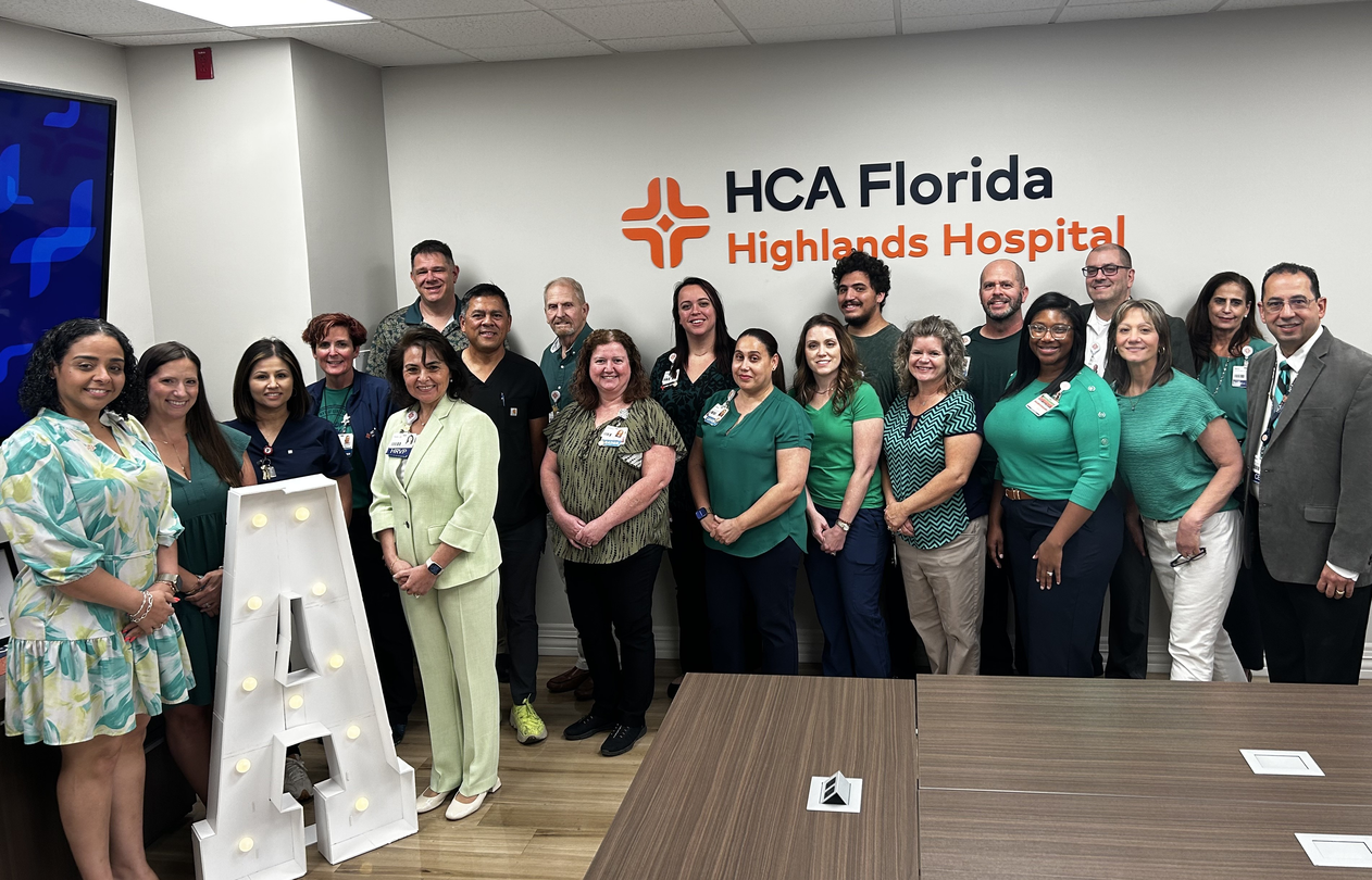 Group of HCA Florida Highlands Hospital colleagues standing around a letter A