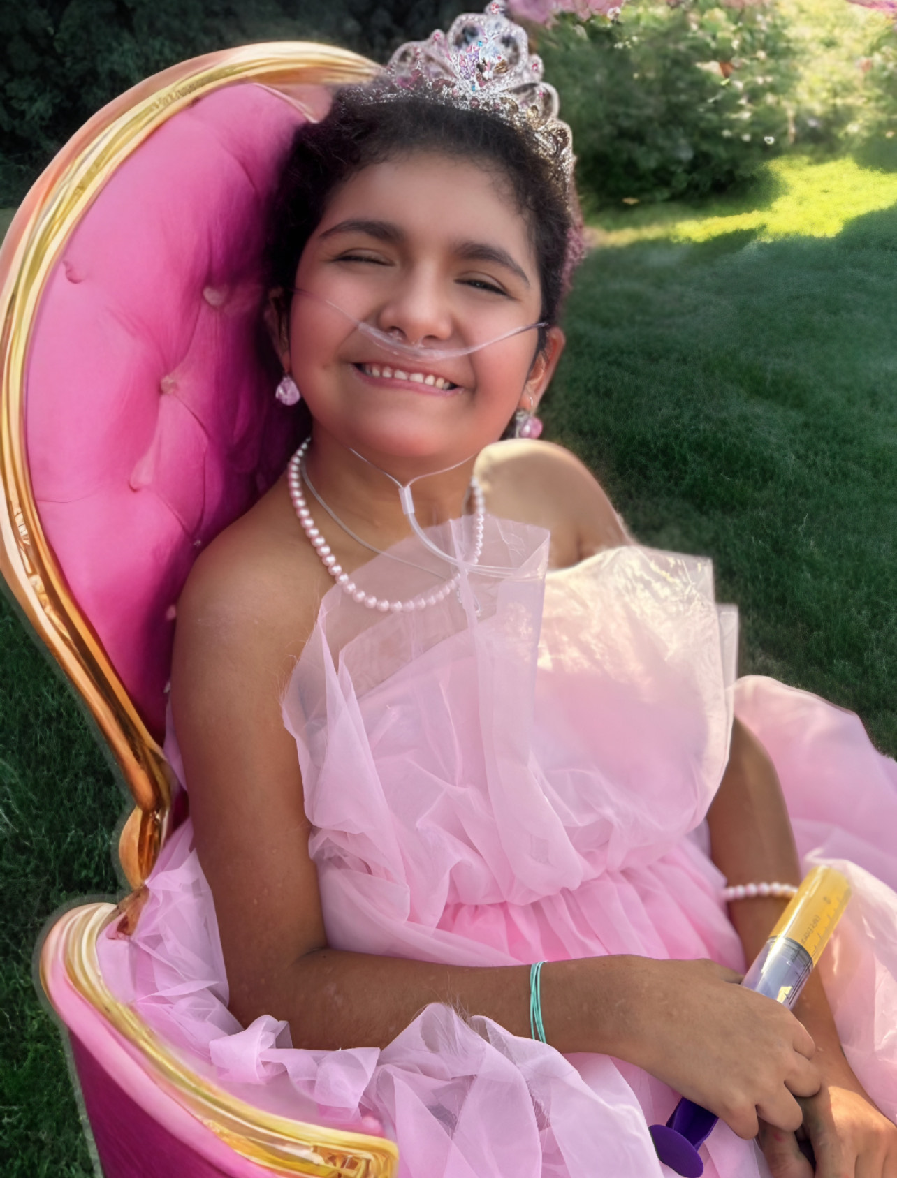 Girl dressed as a princess in a throne