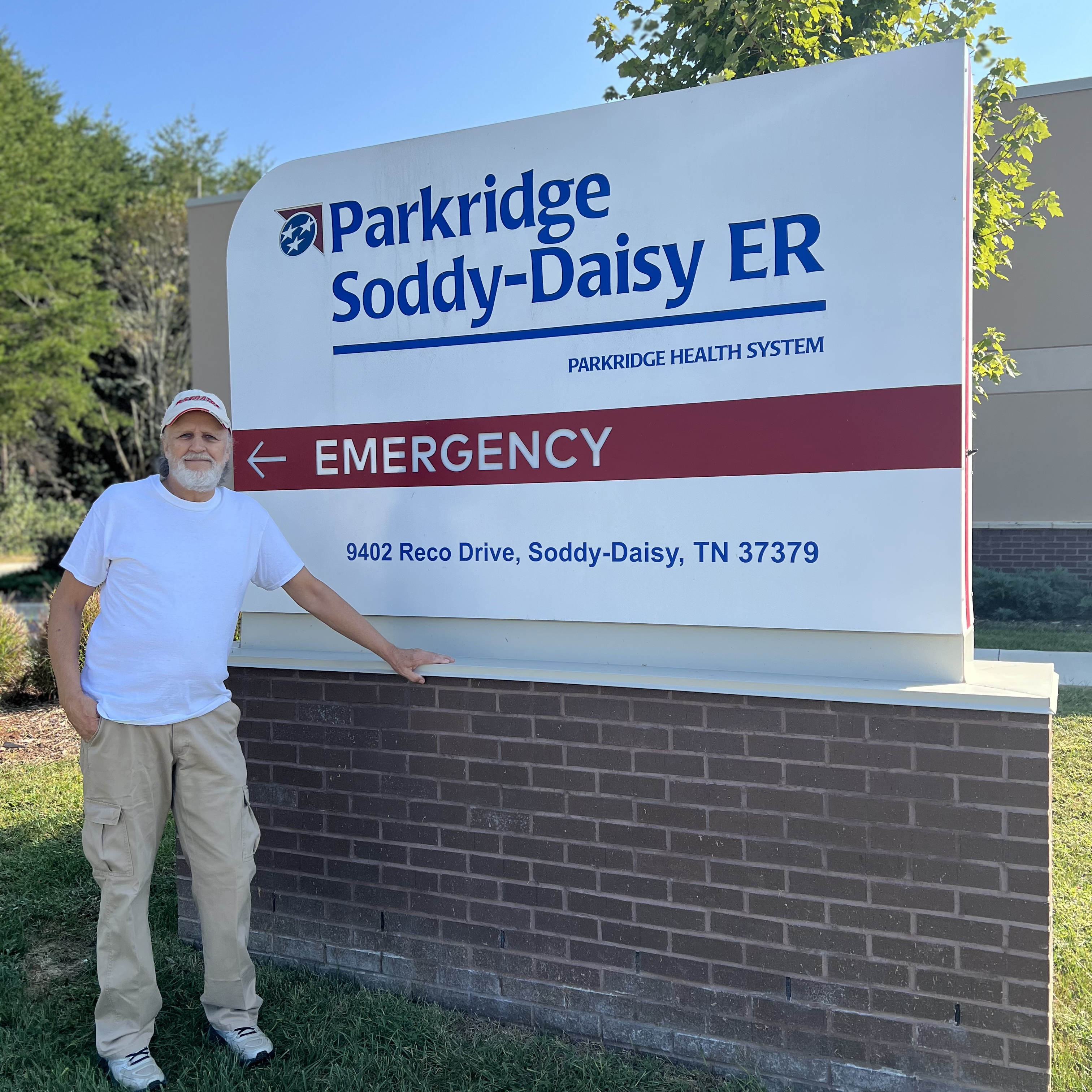 Michael Eddings standing next to the Parkridge Soddy-Daisy ER emergency sign outdoors