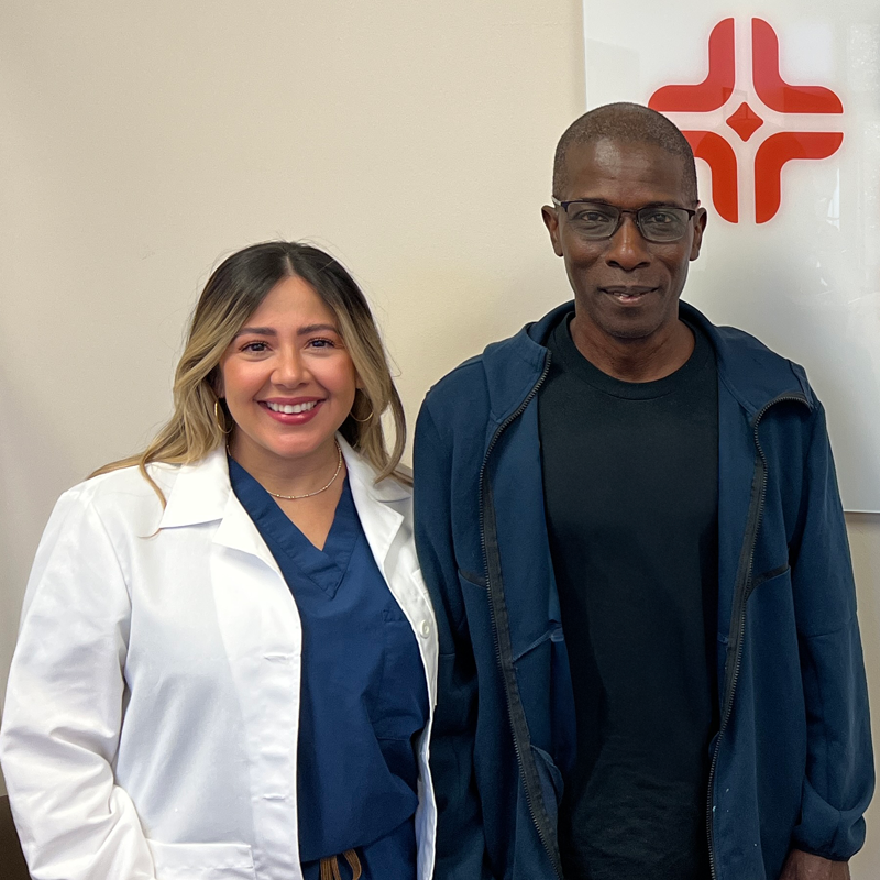 Philip Jones and Dr. Vazquez stand next to other next to the HCA Florida Lake City Surgical Specialists signage.
