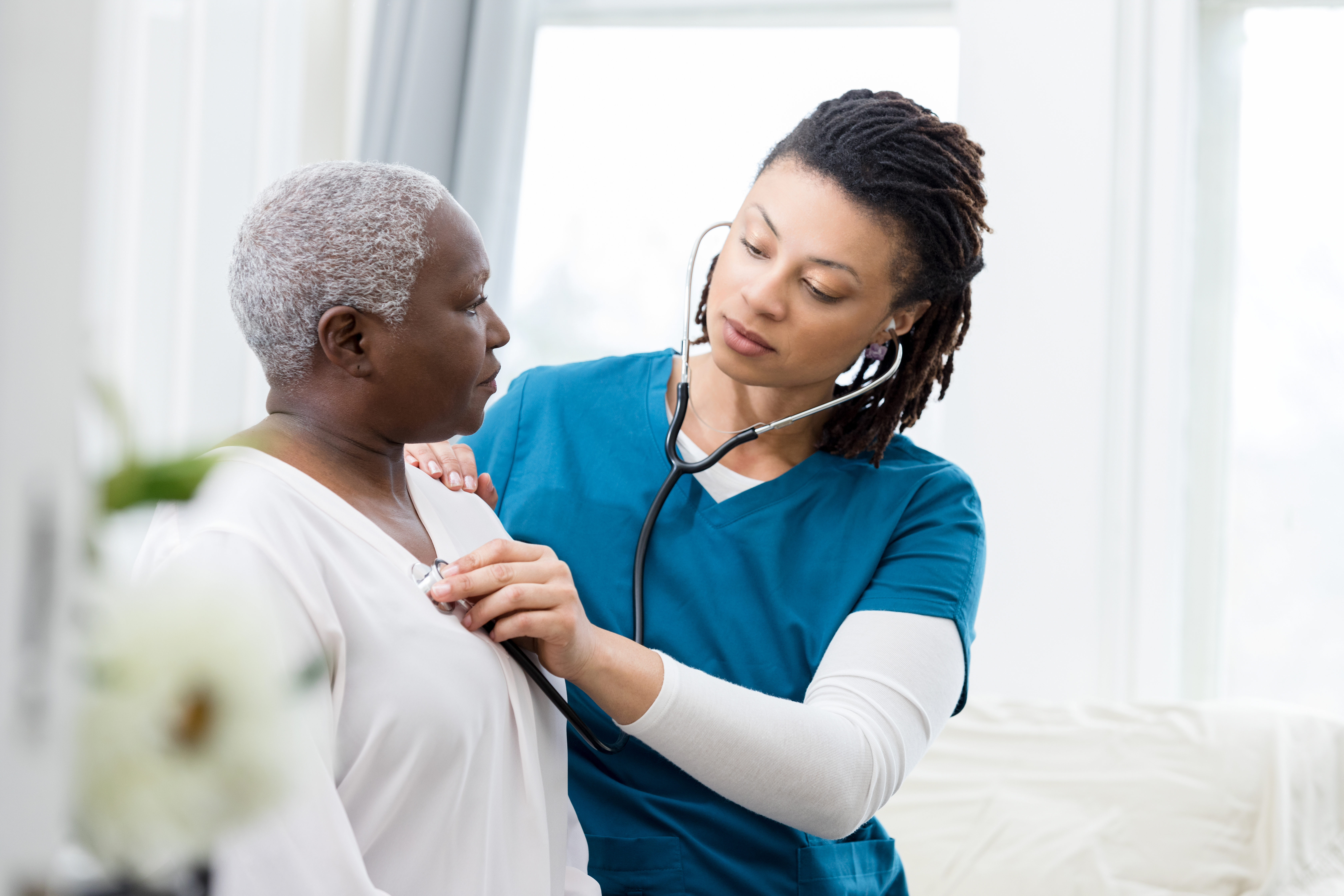 Provider listening to a patient.
