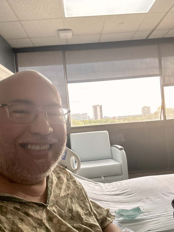 Carlos Tristan smiling in a hospital room