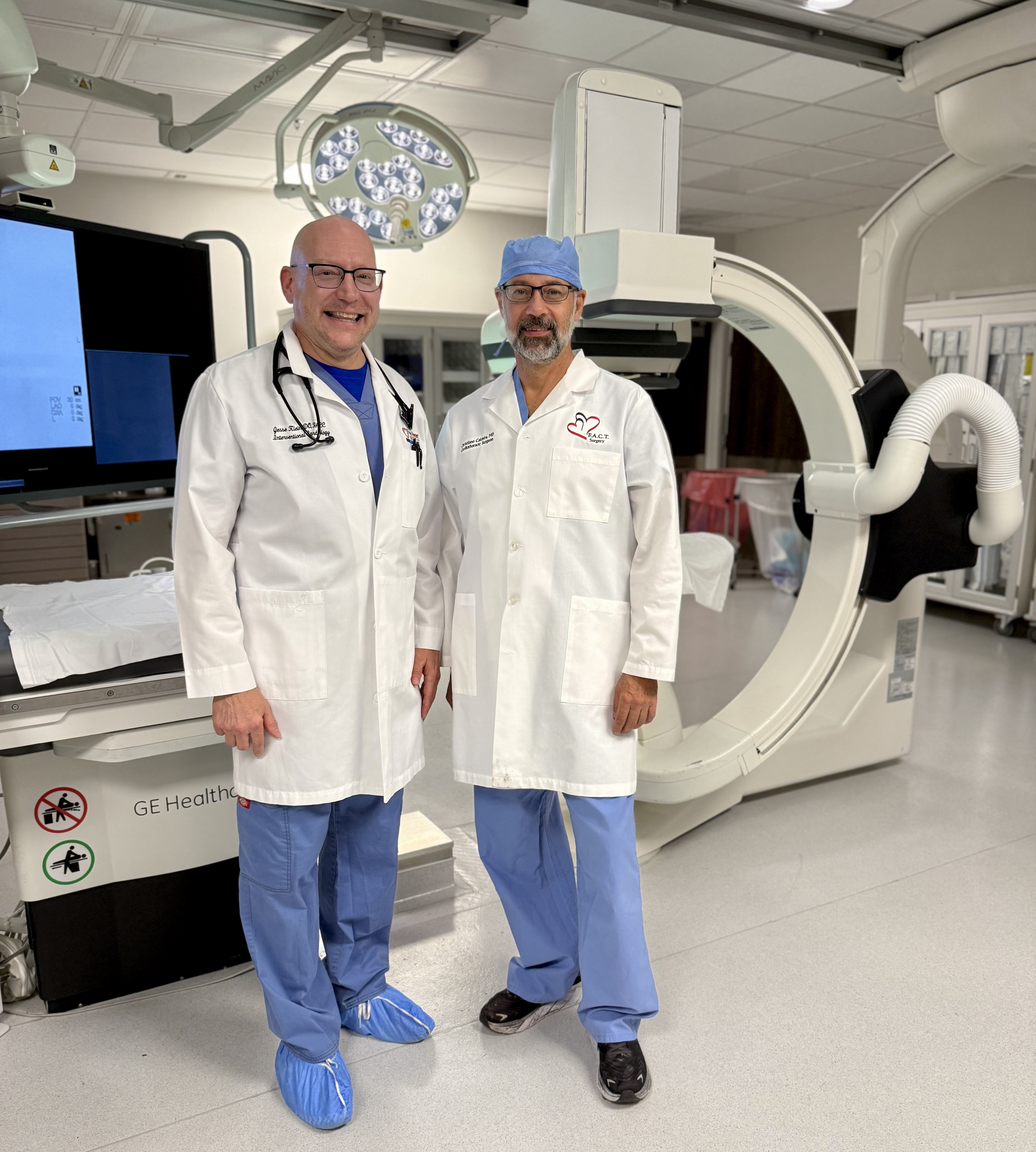 Dr. Christiano Caldeira and Dr. Jesse Klein posing for photo in operating room.
