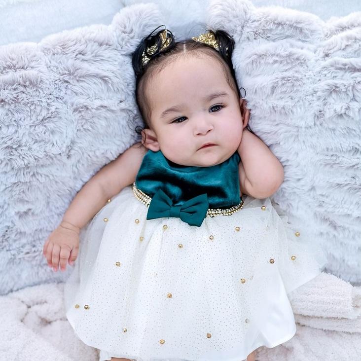 Amaris Lourdes Arredondo NICU baby in Christmas dress, portrait photo