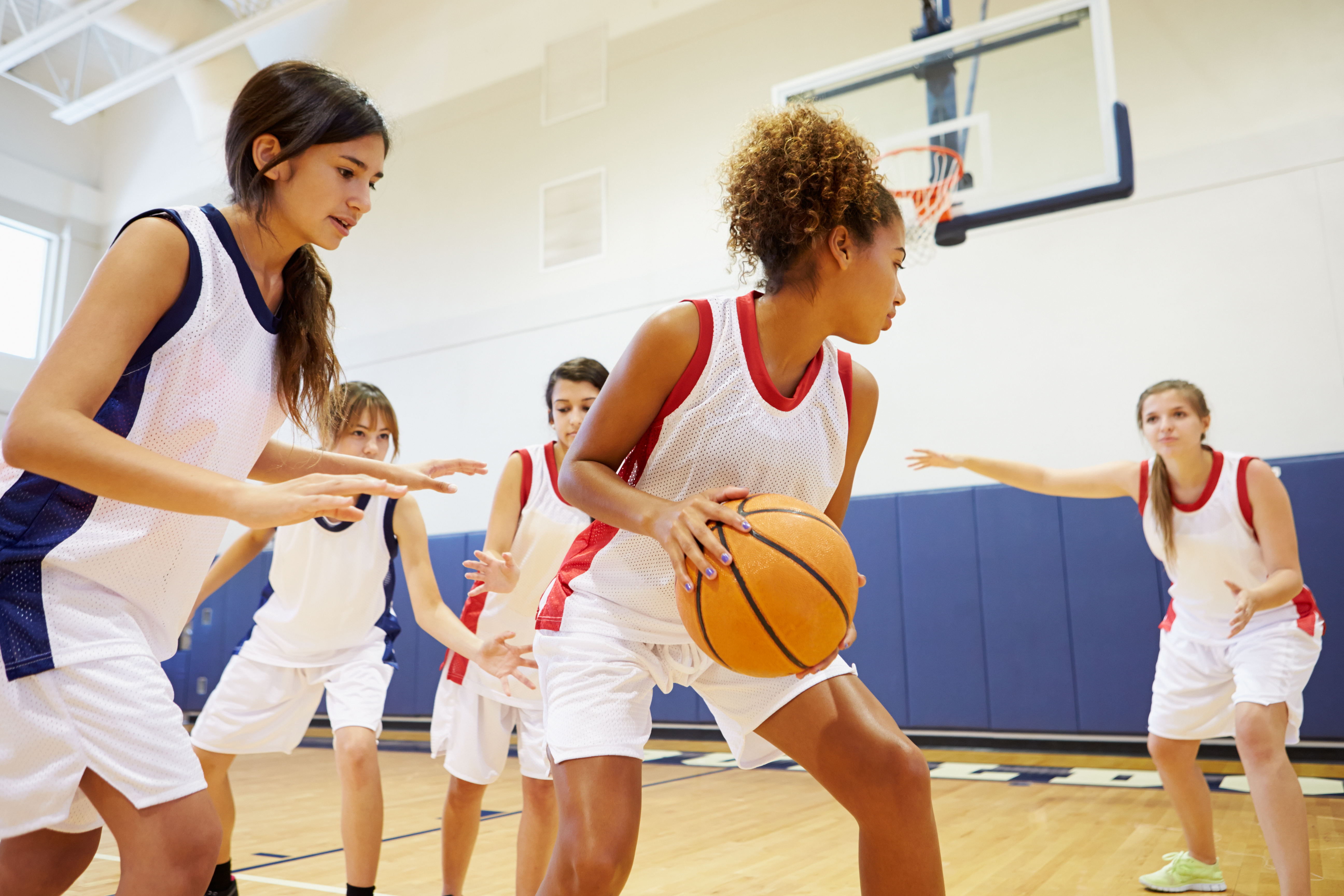 A group of female athletes playing basketball 