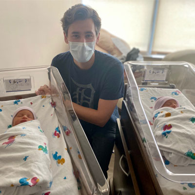 Karina's husband with the twin babies.