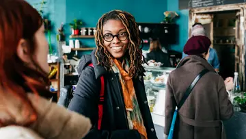 People waiting in line at a cafe.