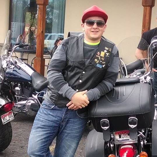 Dylan Wormsbaker posing with his motorcycle.