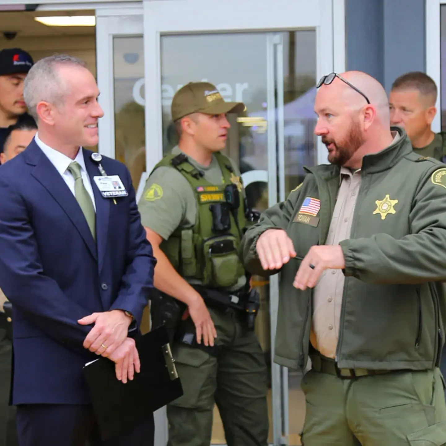 Peter Hemstead and Sheriff Captain Justin Rowan smile while talking during a dedication ceremony honoring Sheriff Deputy Timothy Corlew.