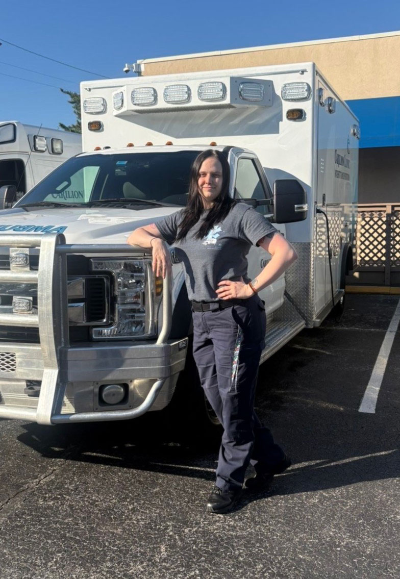 Michaela Seay poses next to ambulence.