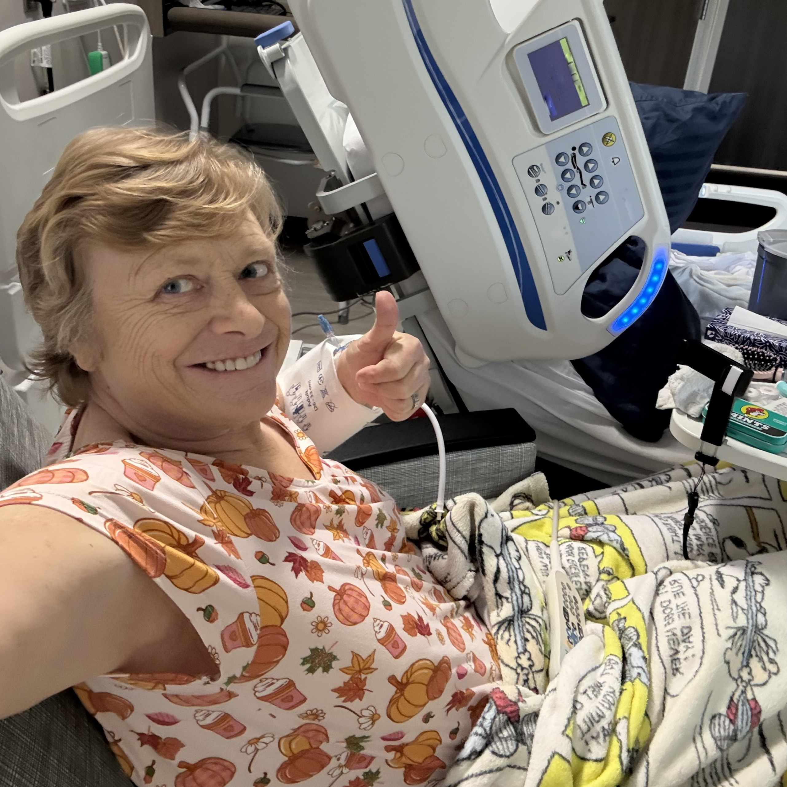 Karen Privitera gives a thumbs up from her hospital bed.