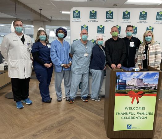 Robert Podnar smiles while standing with the EMS care team that took care of him at Research Medical Center.