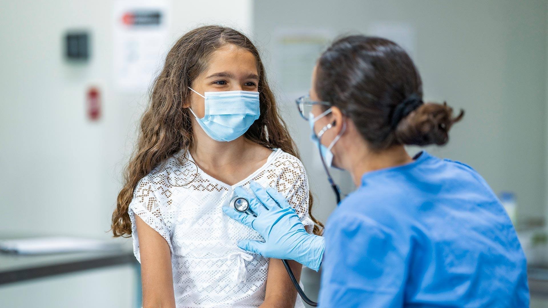 A young girl getting a physical at a doctor's office.