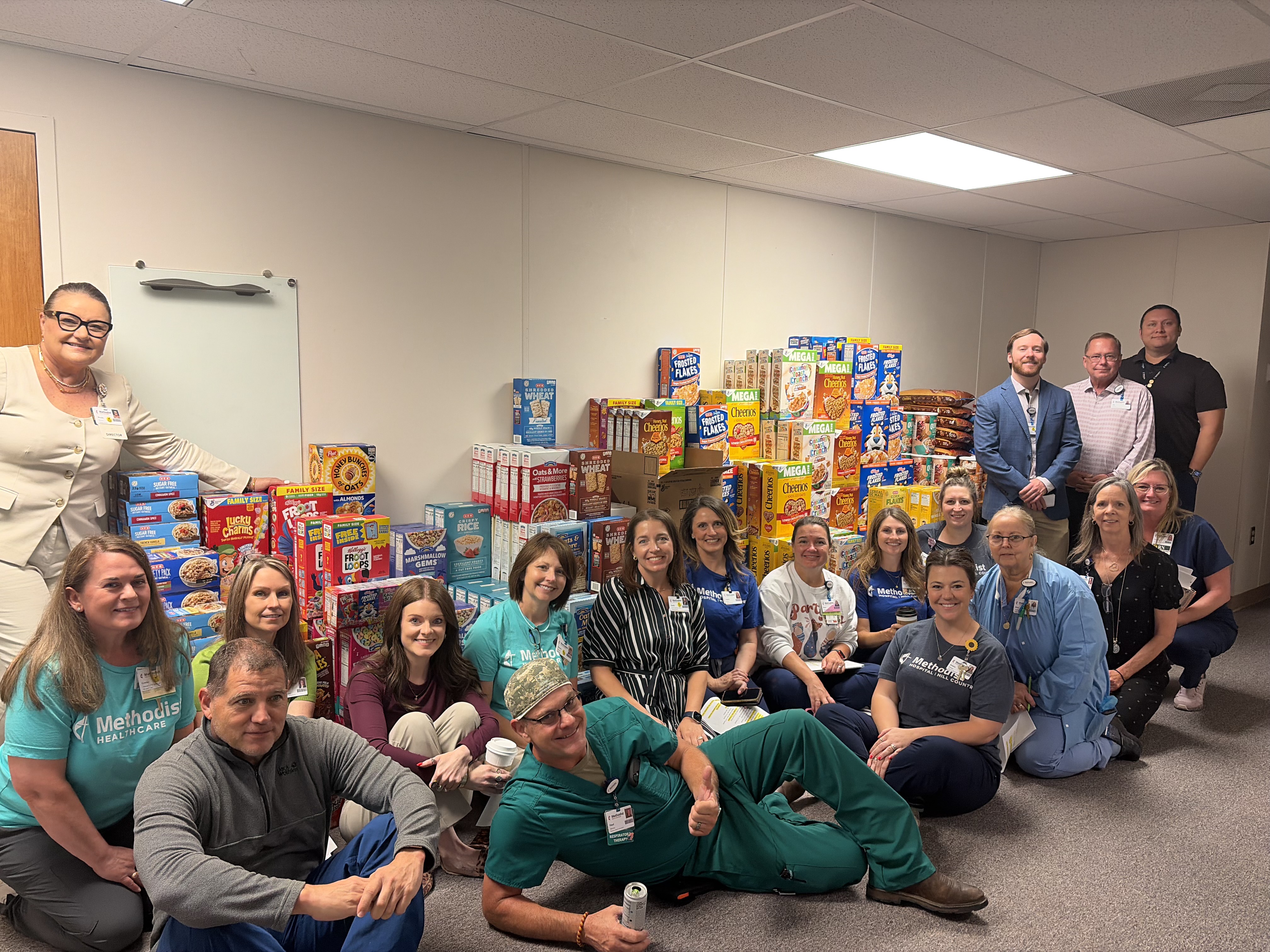 Staff with donated cereal stacked up high.