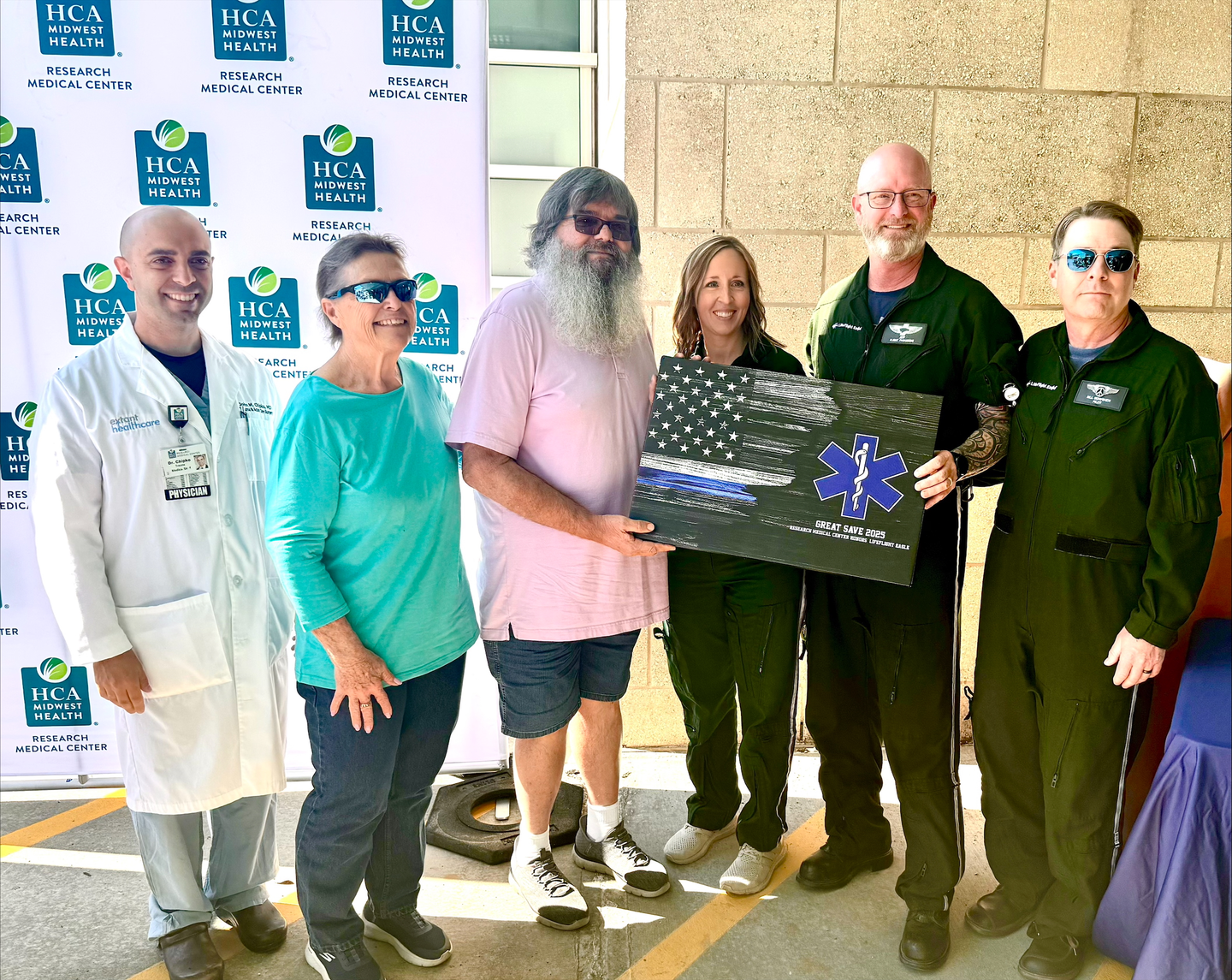 Physicians, care teams, EMS partners, and First Responders with former trauma patient.